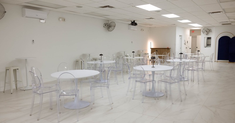 Interior, seating area with chairs and round tables