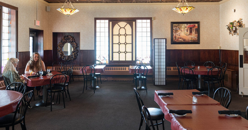 Interior, seating area and two ladies enjoying drinks