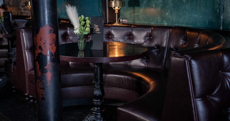 A cozy bar seating area with a round wooden table