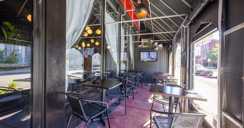 Covered patio area with tables and chairs