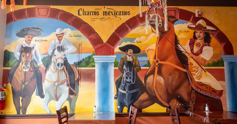 Interior, tables and chairs near painted wall