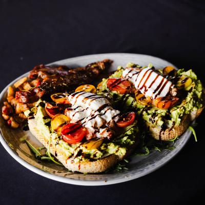 Lobster & burrata avocado toast, served, front view, closeup.