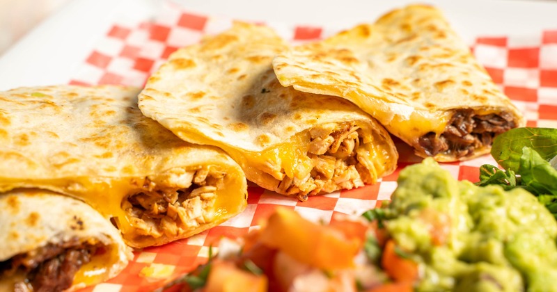 Chicken quesadilla served with pico de gallo and guacamole