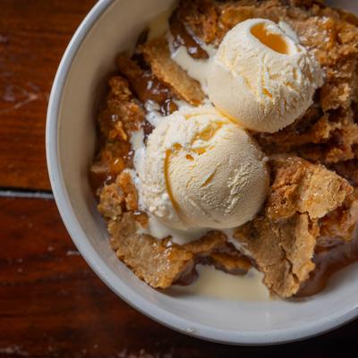 Peach cobbler with ice cream.