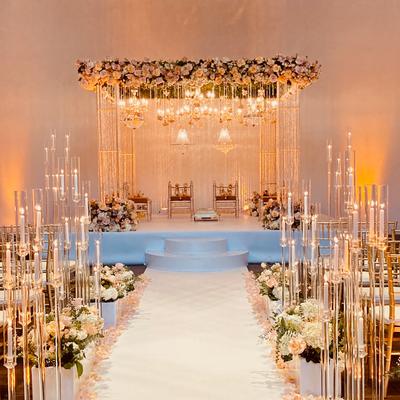 A wedding reception, logs of candles and lights.