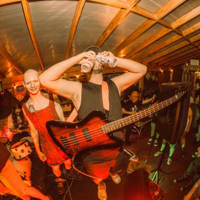 A bassist drinking beer on stage