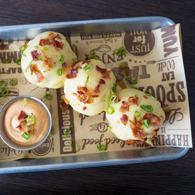 Beer Battered Mac and Cheese Balls with a side of sauce.
