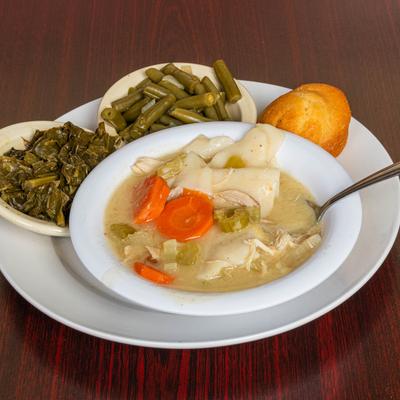 Chicken and dumpling soup served with collard greens, green beans, and cornbread.