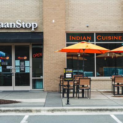 Restaurant entrance with an outdoor seating area.