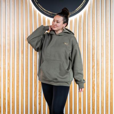 Woman in an olive green ''Hula Pot'' hoodie, front view.