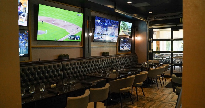 Interior, tables, chairs and buttoned, black leather benches