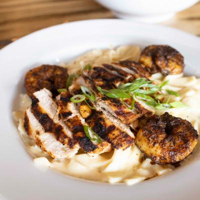 Creamy fettucine Alfredo pasta topped with blackened chicken and shrimp.