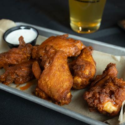 Wings served with ranch and beer.