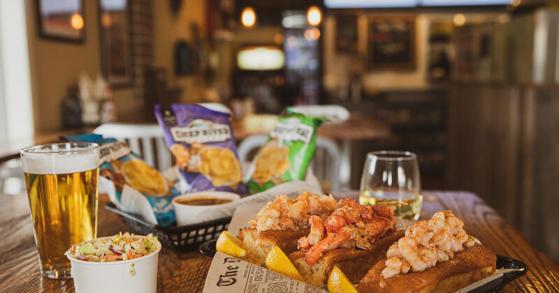 Nachos with dips, seafood rolls and beer