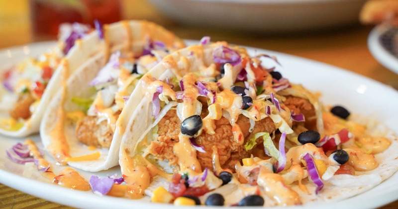 Loaded fish tacos topped with colorful slaw