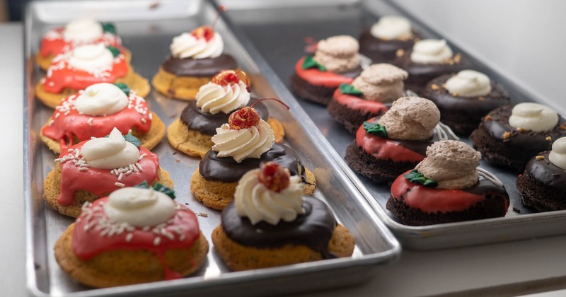 Two trays of cookies with colorful icing