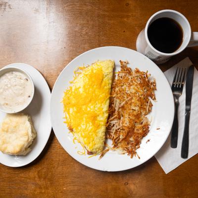 Omelet with hashbrowns, biscuit, gravy, and coffee.