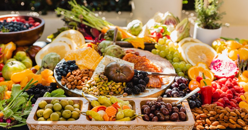 Catering table with a plethora of vegetables, fruits and nuts