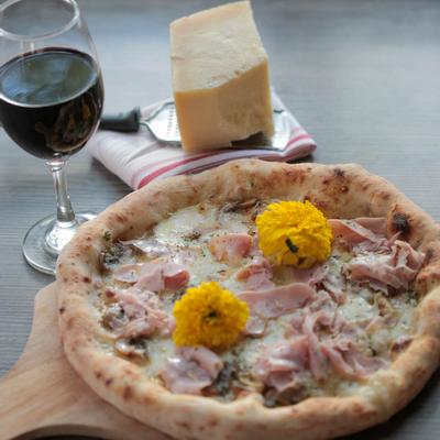 Pizza , glass of red wine on the side