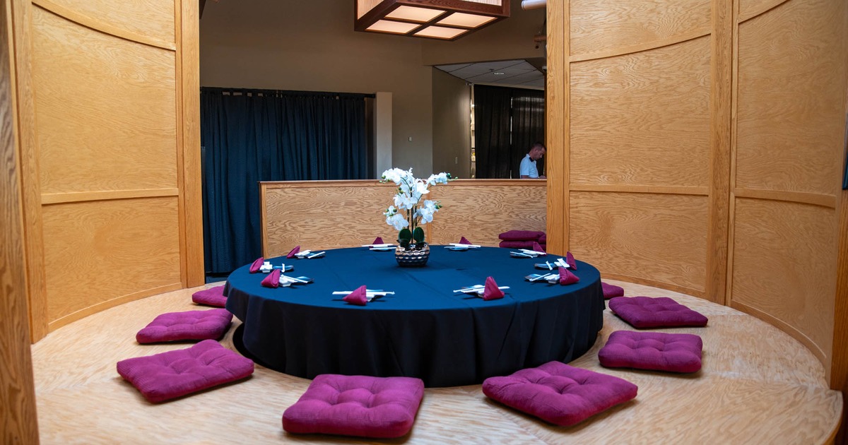 Interior, traditional Chabudai table with pillows for seating, ready for guests
