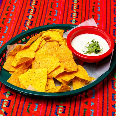 Queso dip served with tortilla chips.