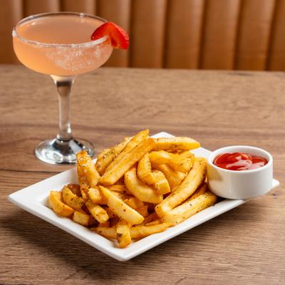 French fries, ketchup, and a cocktail.