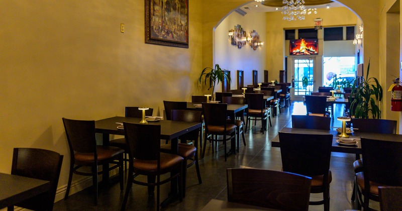 Interior, tables ready for guests, a picture on the wall