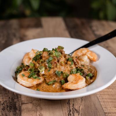 Crawfish etouffee topped with shrimp and scallions.