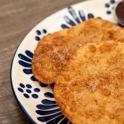 Mexican crispy fried pastries coated in cinnamon and sugar.