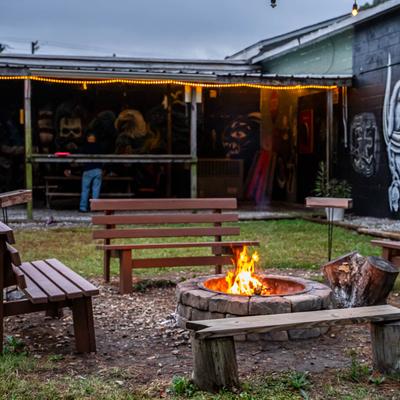 A camp fire and benches at the outside patio.