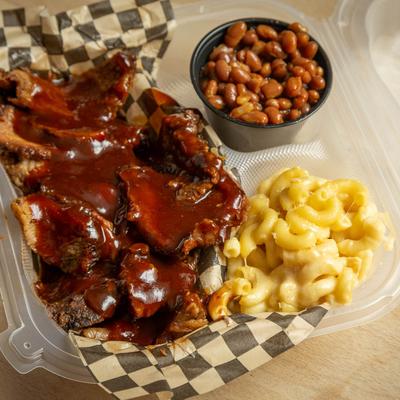 Sliced  Tri Tip with baked beans and mac and cheese on the side.