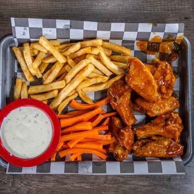 Buffalo wings with fries, carrot sticks, and ranch dipping sauce.