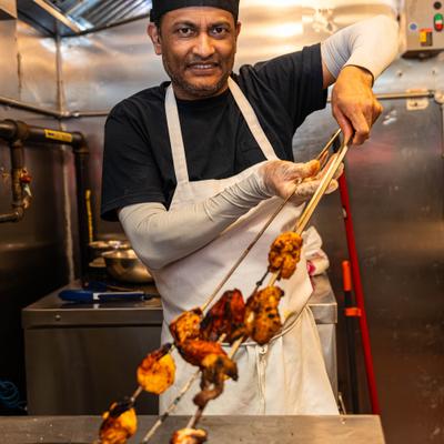 Chef skewering meats.