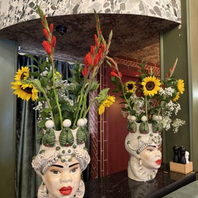 Two Large ceramic bust vases as decoration with flowers.
