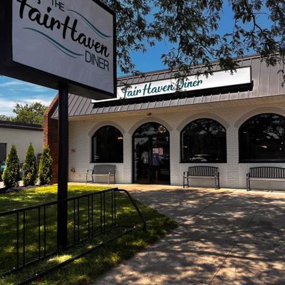 View at the restaurant's entrance and sign.
