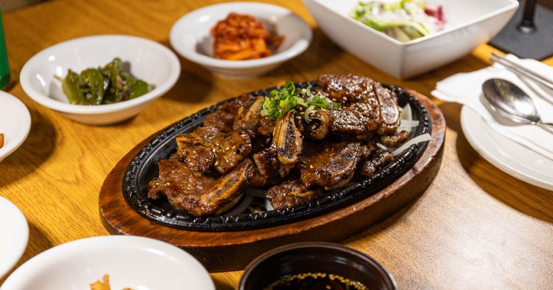 Korean BBQ marinated beef short ribs served with various sides