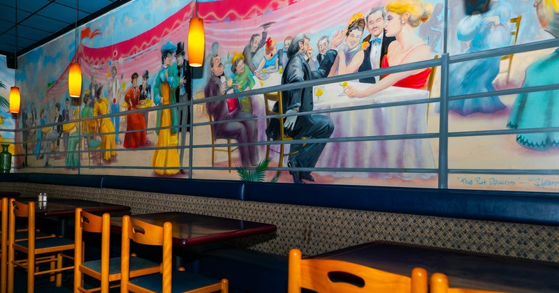 Interior, tables and chairs near painted wall