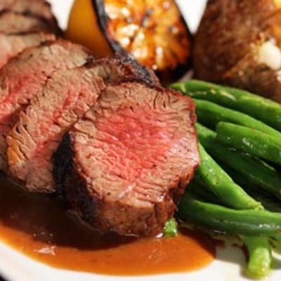 Beef tenderloin served with green beans.