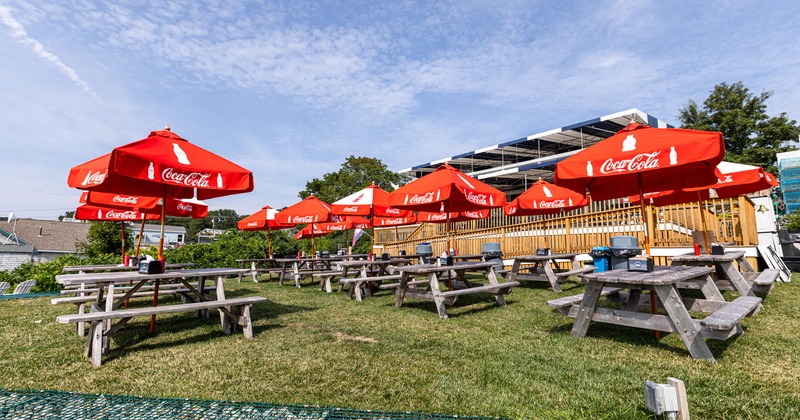 Exterior, lawn patio with wooden tables, parasols and bench seating