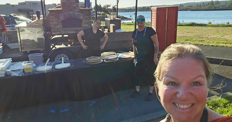 A person posing in front of a buffet setup