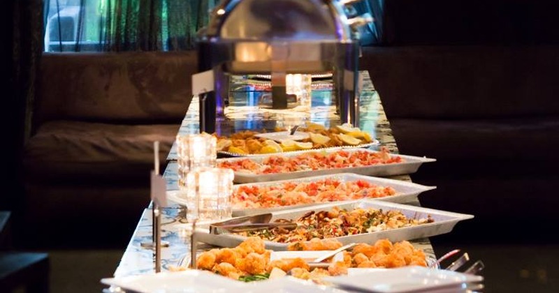 Buffet table with food trays and chafing dishes