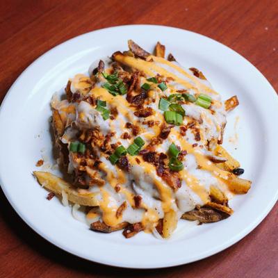 Loaded fried topped with bacon, mac and cheese, sausage, and scallions.
