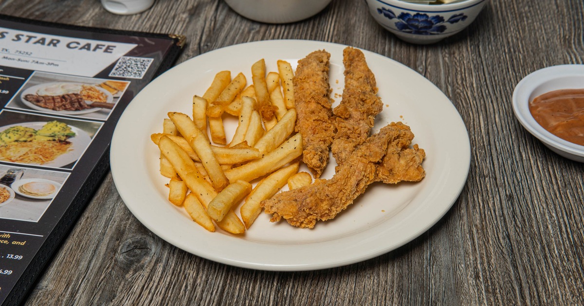 Crispy chicken tenders alongside golden fries