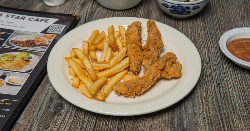 Crispy chicken tenders alongside golden fries
