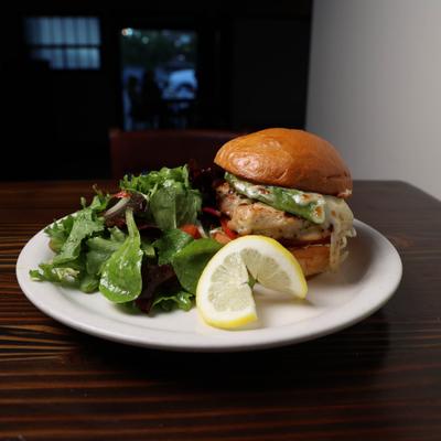 Grilled Chicken Sandwich on brioche bun  with side salad.