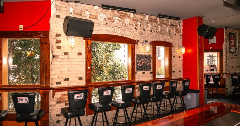 Interior, table ledge seating with bar stools, large windows with wooden frames