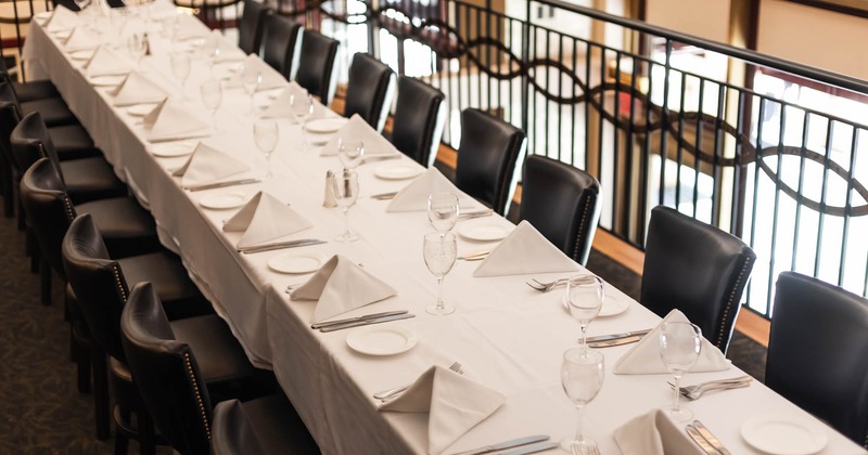 Interior, a long dining table elegantly set for a formal meal