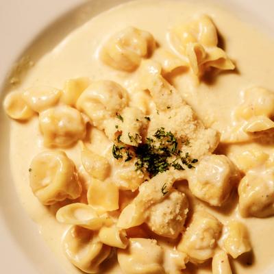 Stuffed pasta in creamy sauce, topped with Parmesan cheese and herbs.