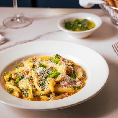 Creamy pasta with sausage, broccoli rabe, and grated Parmesan.