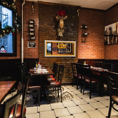 Interior with exposed brick walls and a mix of booth and table seating.